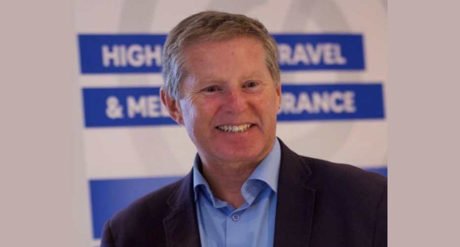 A man in jacket and shirt smiling