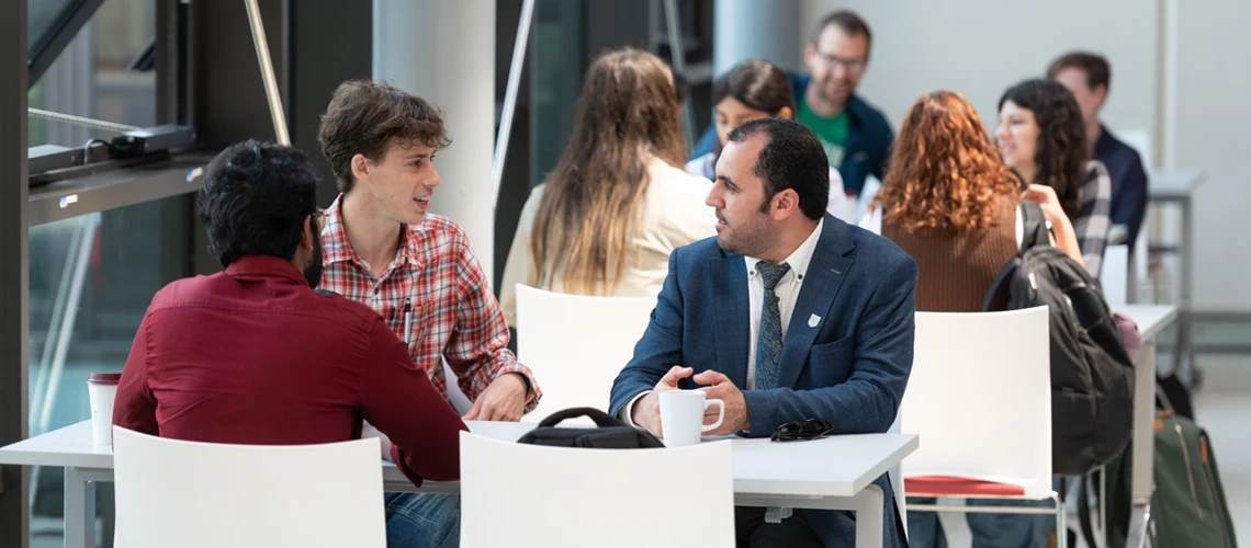 University of Exeter students and staff talking in the Forum.