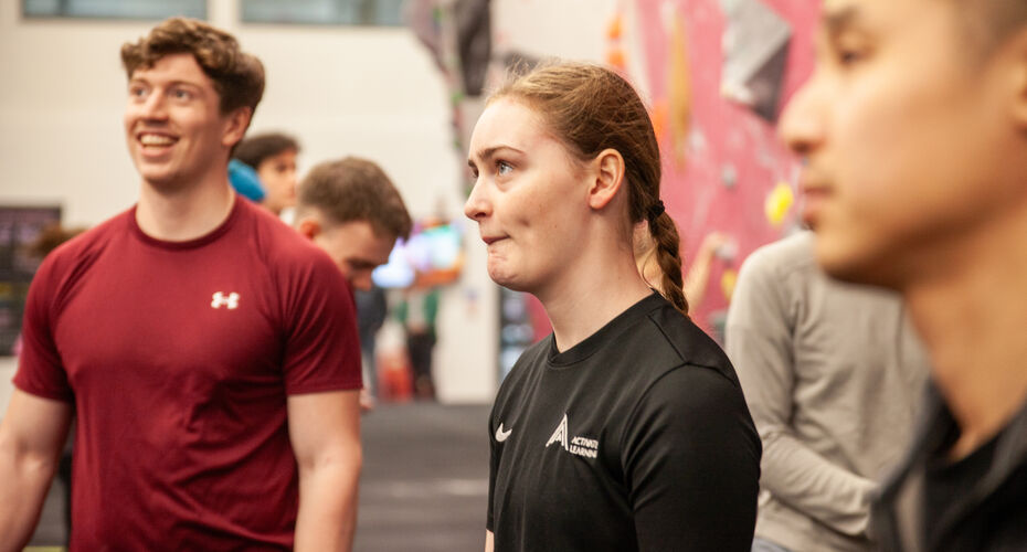 sports science students using climbing wall