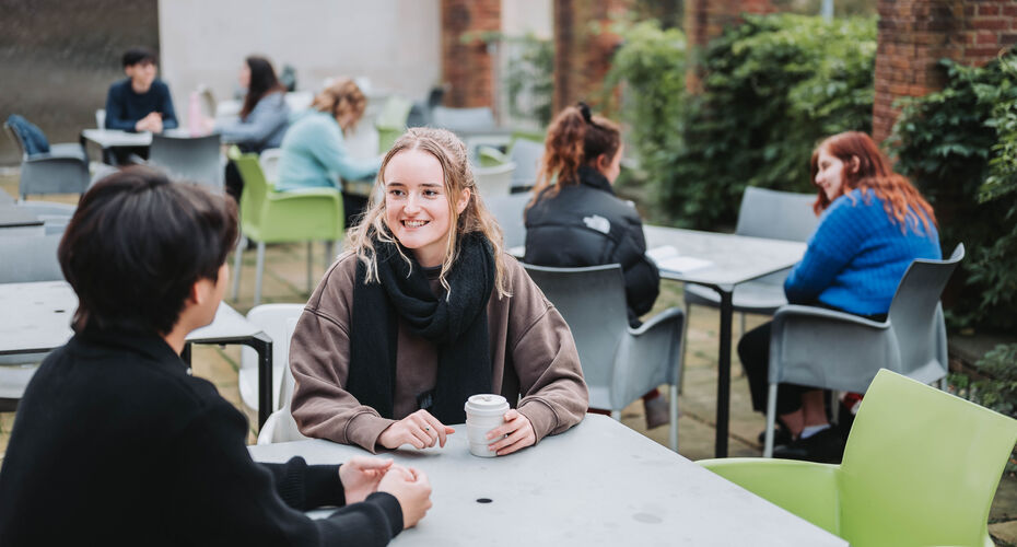 students sitting in cafe space talking