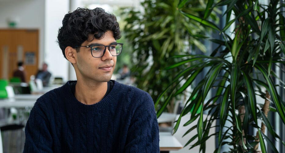 A Business School student sat in a cafe on campus