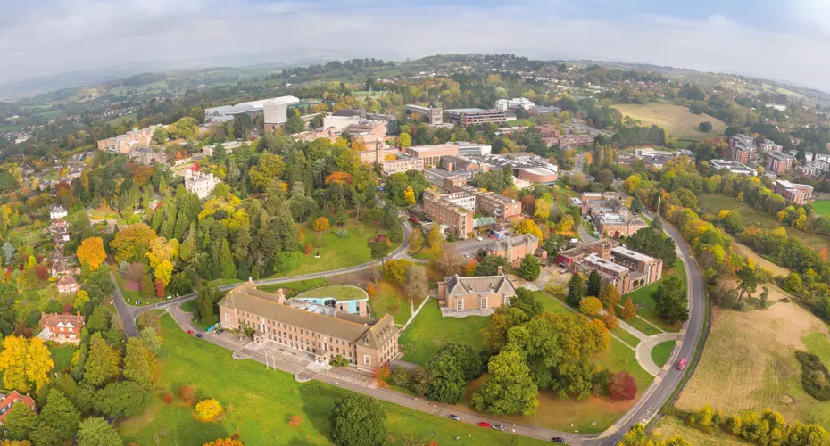 Aerial view of streatham campus in exeter, showcasing vibrant fall foliage across the college grounds.