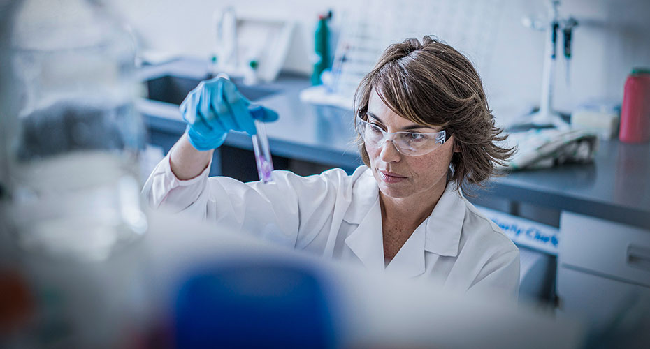 Female scientist in Lab looking at test tube