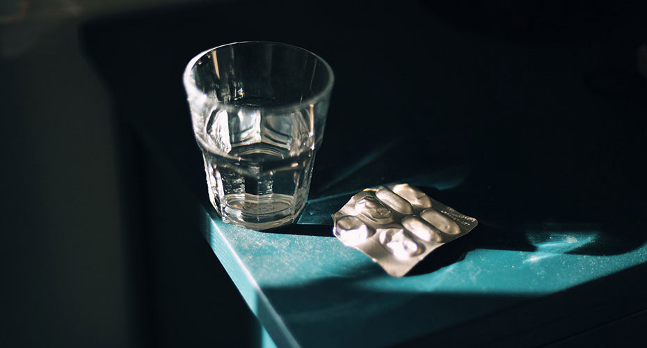 Glass with tablets in dark
