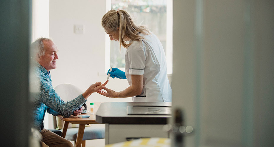 Nurse takes finger prick blood test insulin