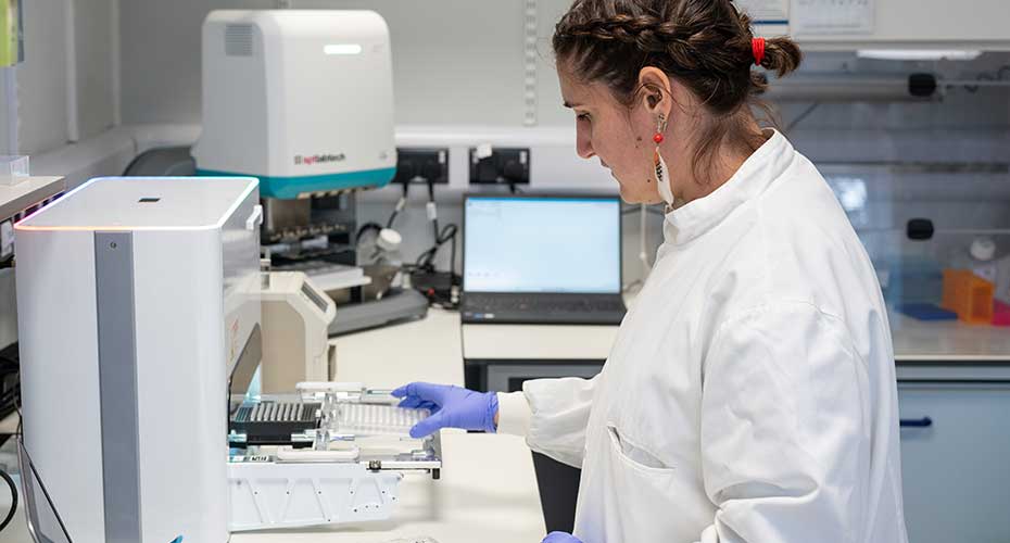 Scientist working with sequencing equipment