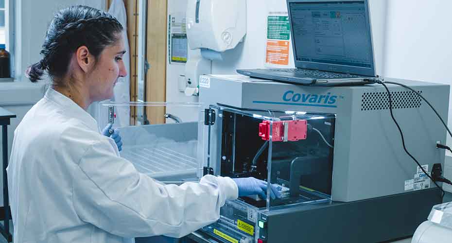 Scientist using a Covaris machine