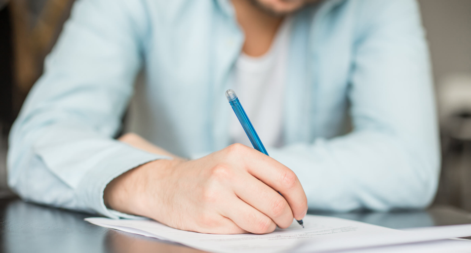 A stock image of a person writing something