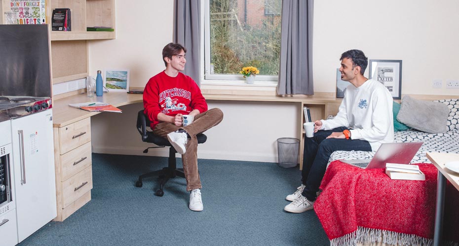 Students chatting in a bedroom