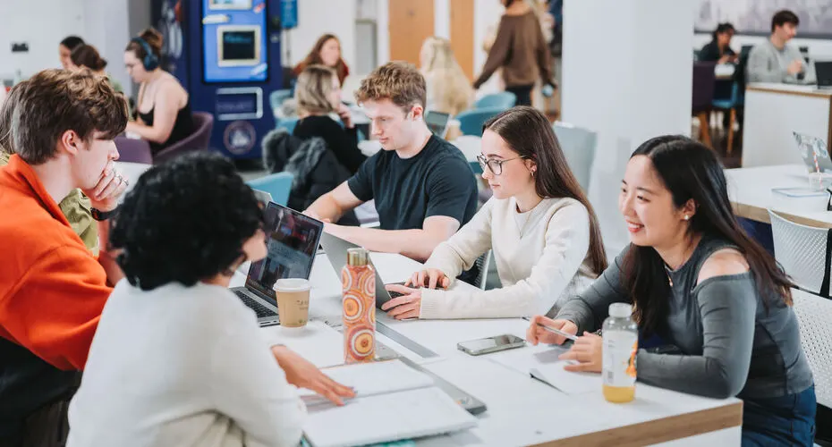 A group of students studying together in a communal space on campus.