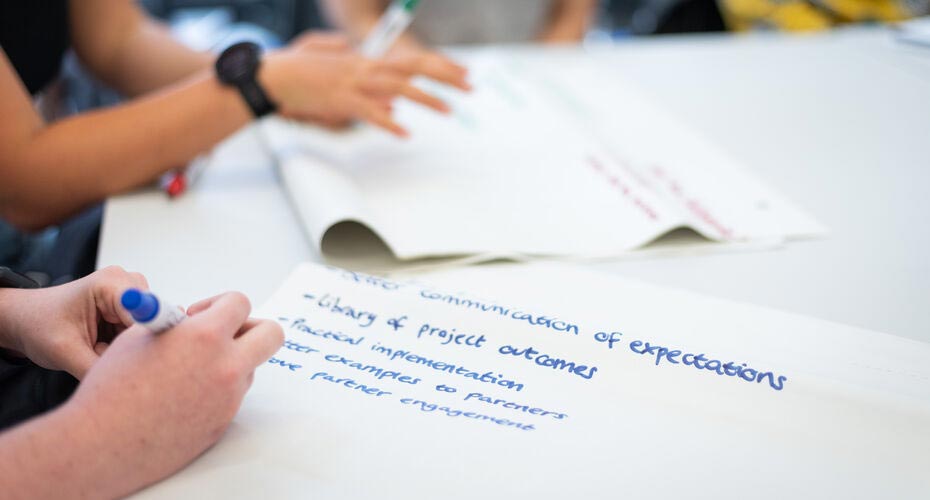 Close-up of somebody writing on flipchart paper