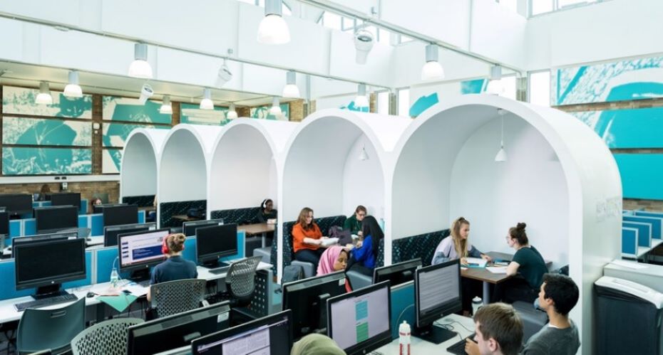 The library at the University of Exeter, a modern architectural marvel, filled with books and study spaces.