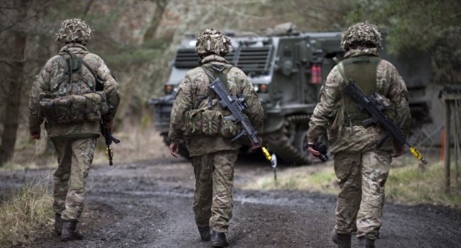 Armed forces walking towards vehicle