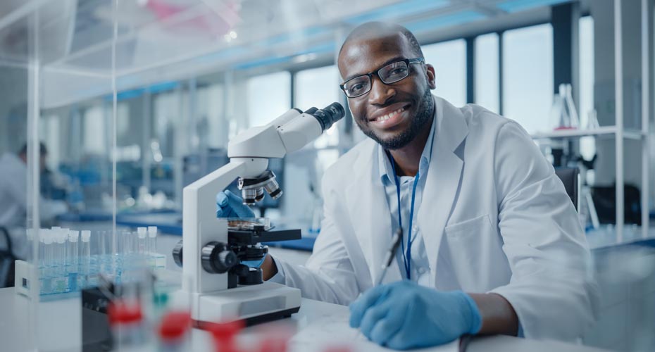 Research student with microscope