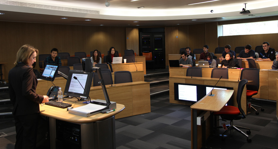 Students and a lecturer in a small lecture theatre.