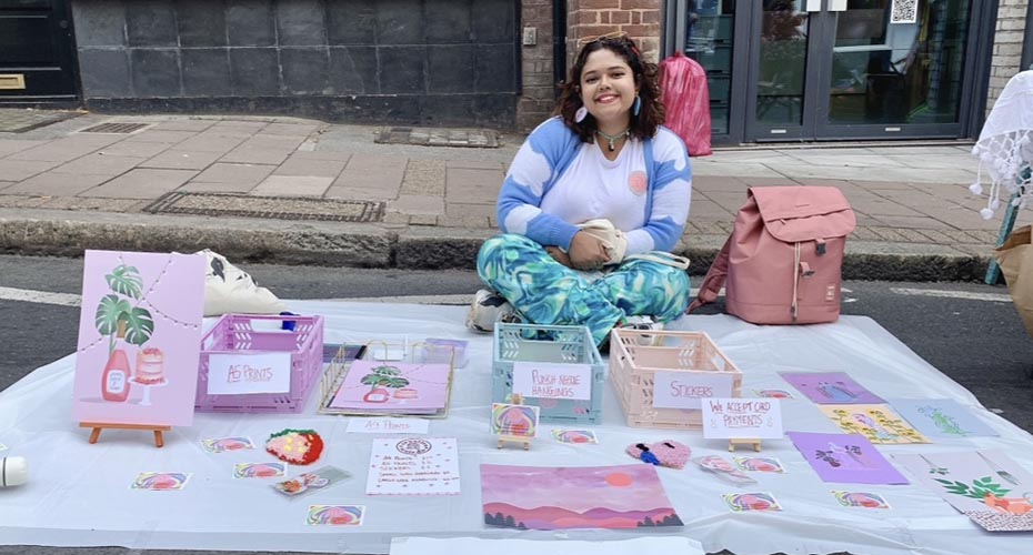 Ridi displaying her artwork at a local market
